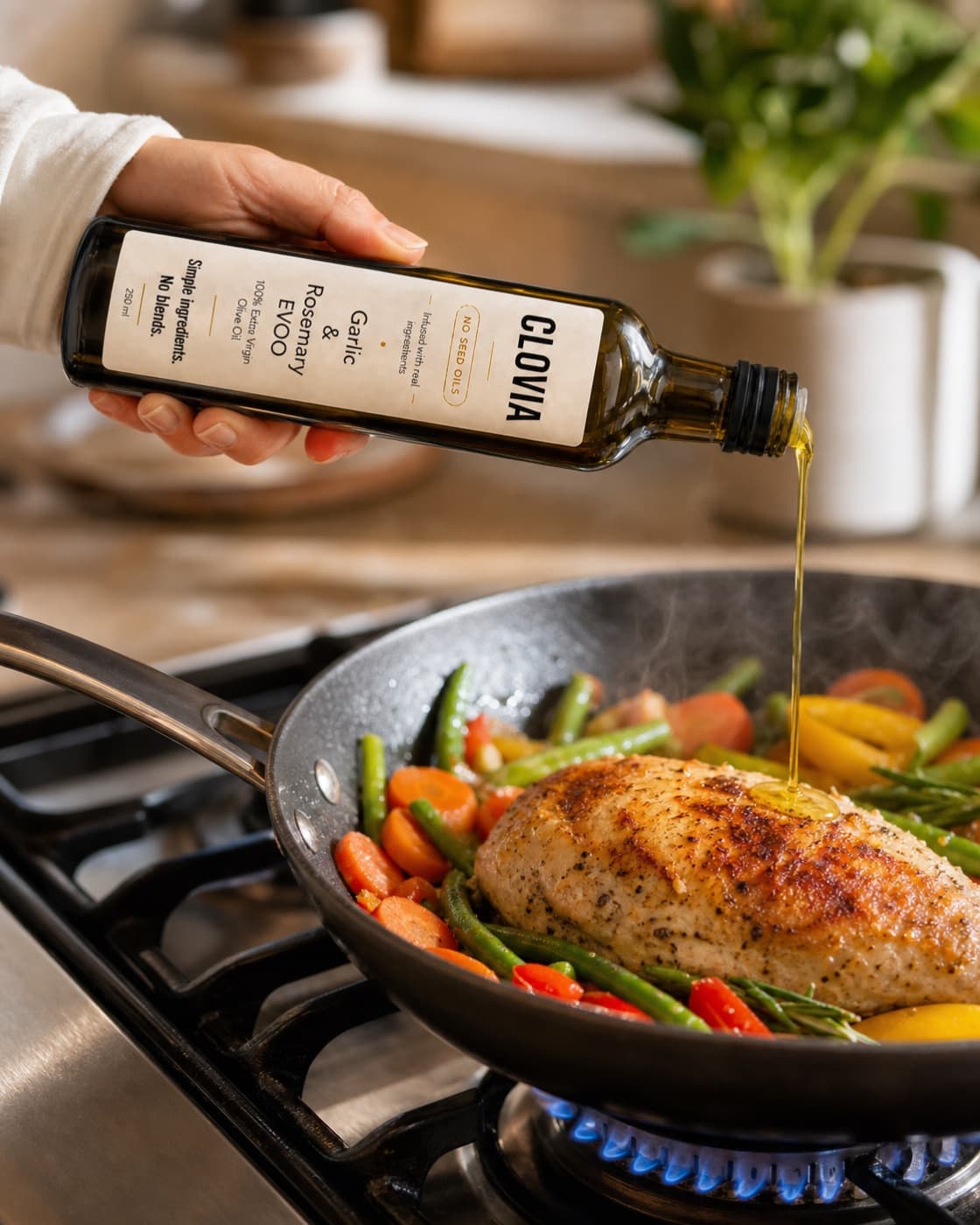 Clovia bottle pouring oil over a hot skillet